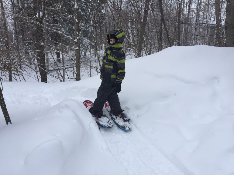 Walking in the woods in snow shoes.